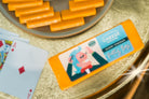 Slice of "Pretty Boy" Sharp Cheddar cheese from Cheese Brothers, Inc., showcasing its rich orange color and smooth texture.