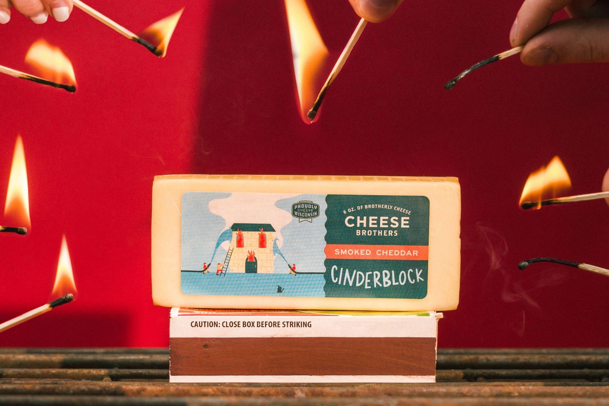 A block of smoked cheddar cheese from Cheese Brothers, Inc., showcasing its rich, golden-brown smoked rind and creamy interior.