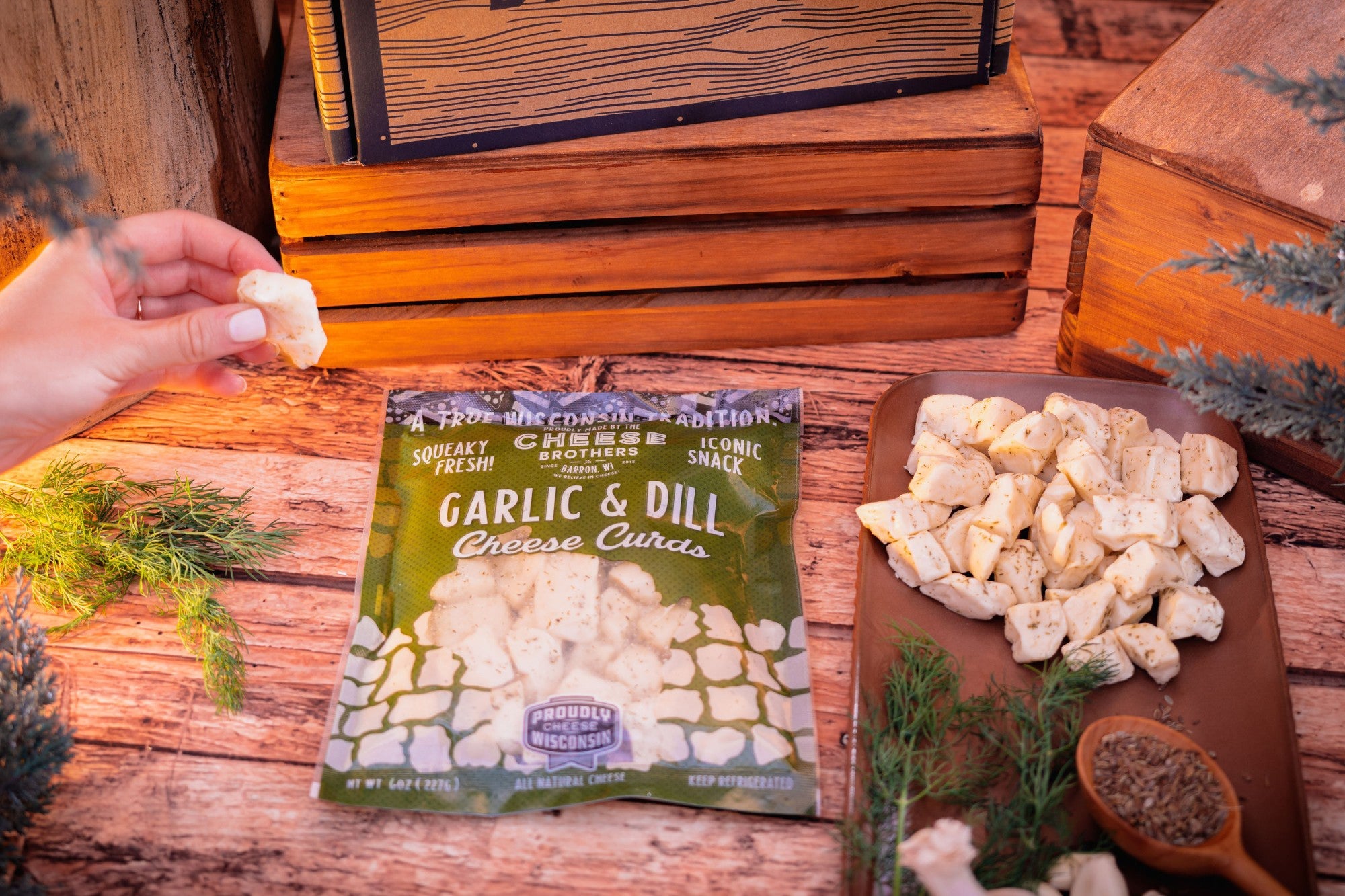 Garlic and dill cheese curds from Cheese Brothers, Inc. showcasing fresh, creamy cheese with herbs and garlic flavoring.