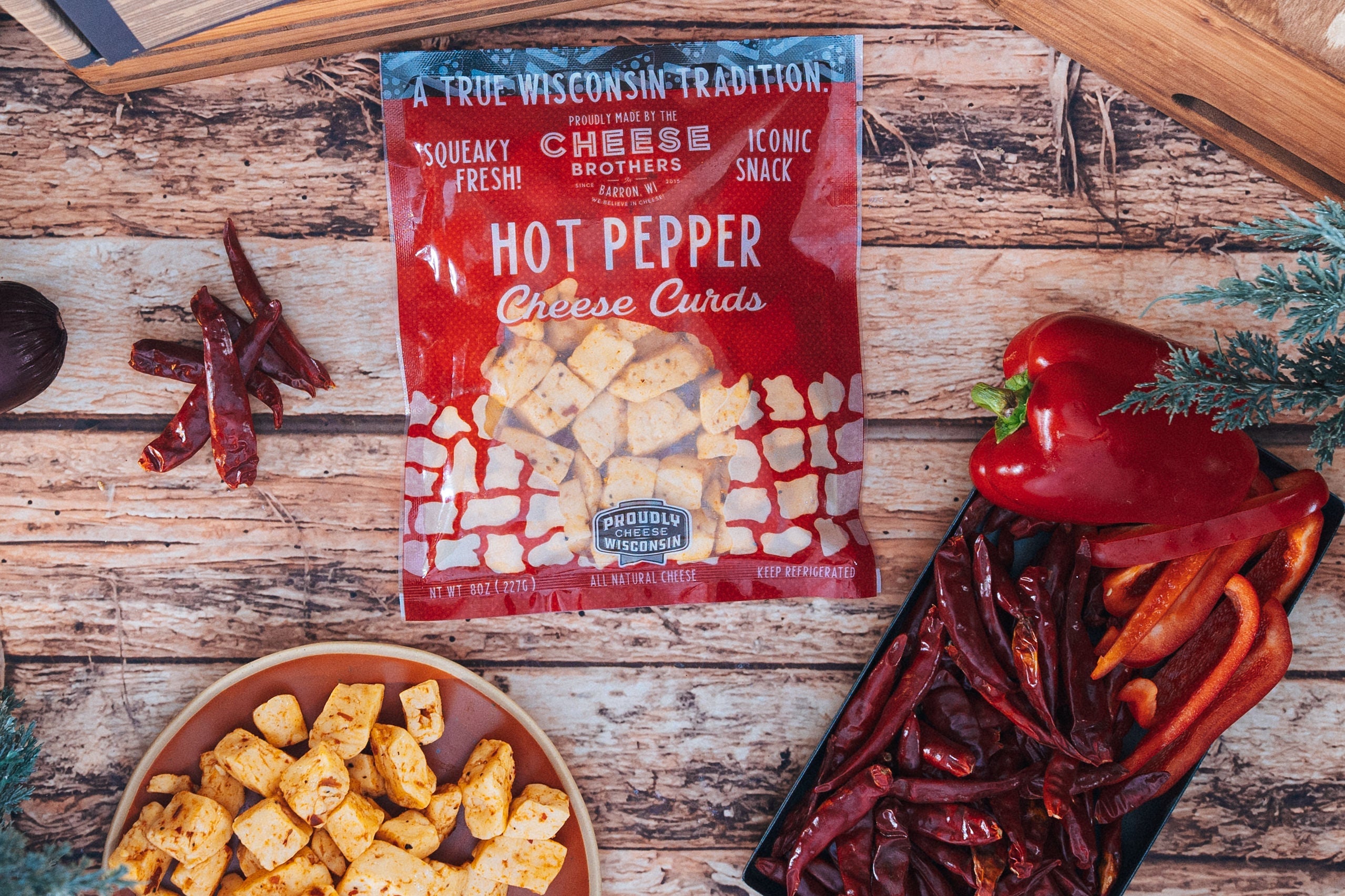 Cheese Brothers hot pepper cheese curds with visible hot peppers and melted cheese, fresh and flavorful snack or appetizer.