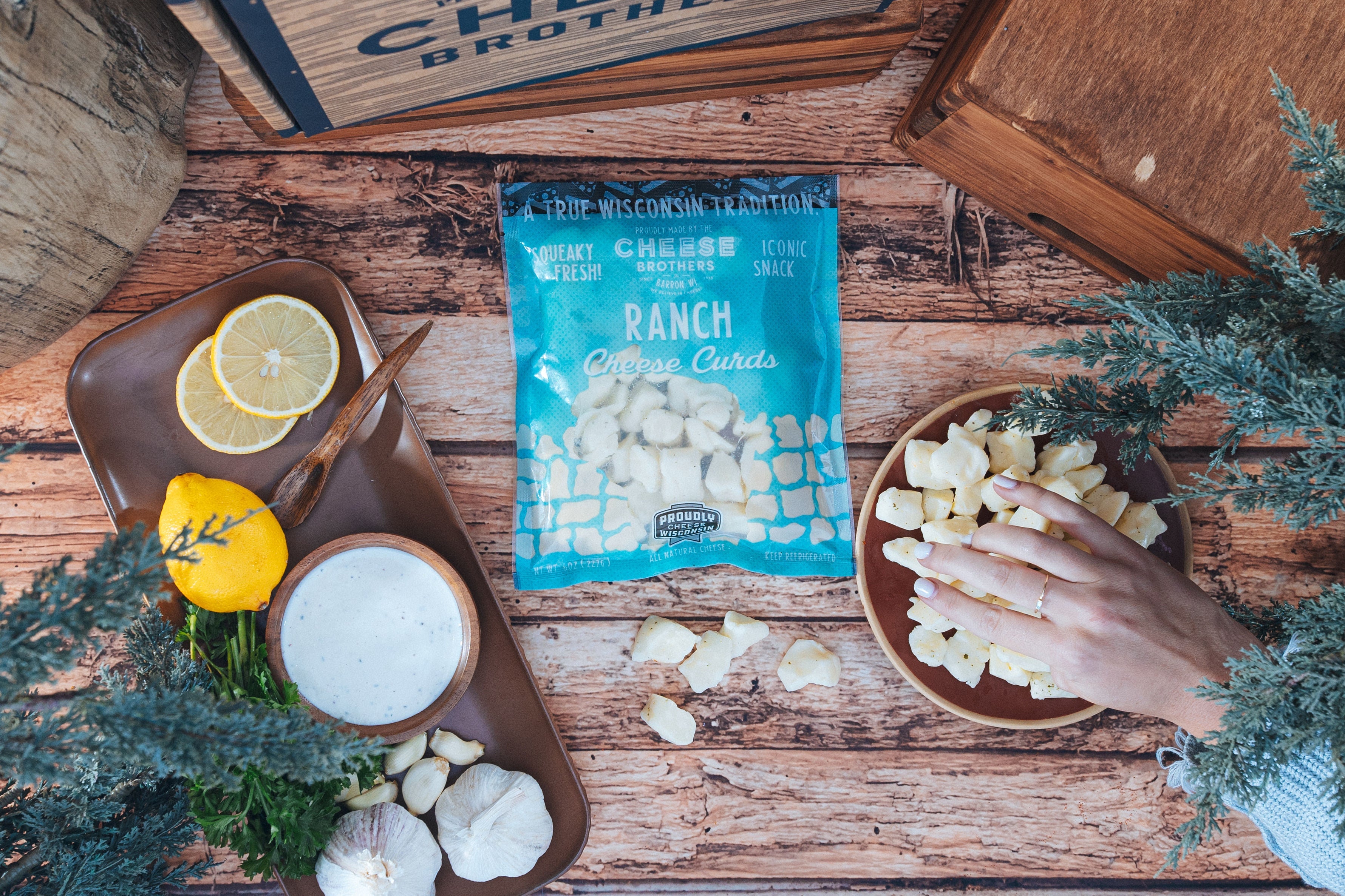 Creamy Ranch Cheese Curds by Cheese Brothers, Inc., showing fresh, white cheese curds in a rustic setting.