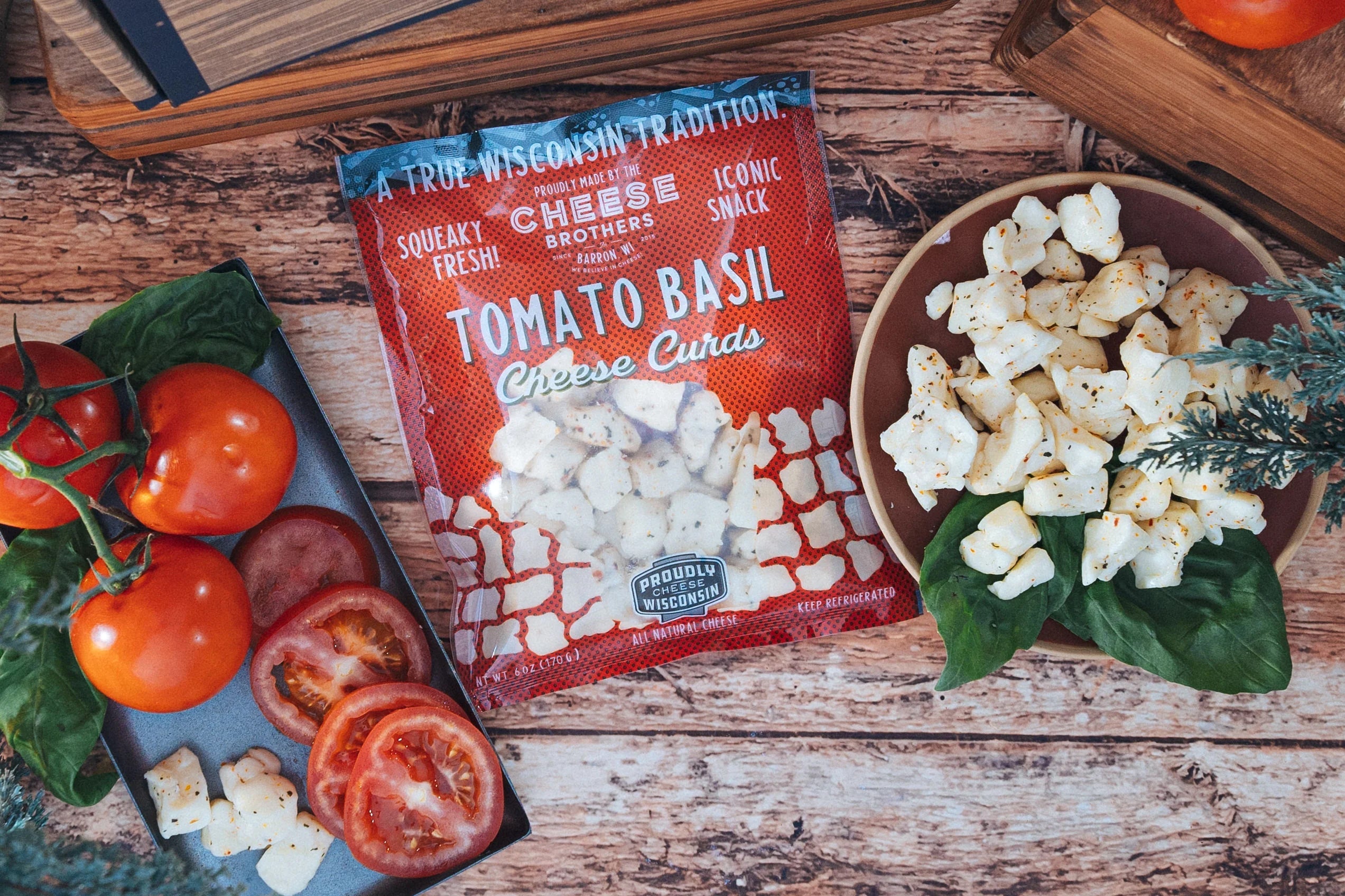 Fresh Tomato Basil Cheese Curds by Cheese Brothers, Inc. showing creamy cheese curds with fresh tomato and basil pieces.