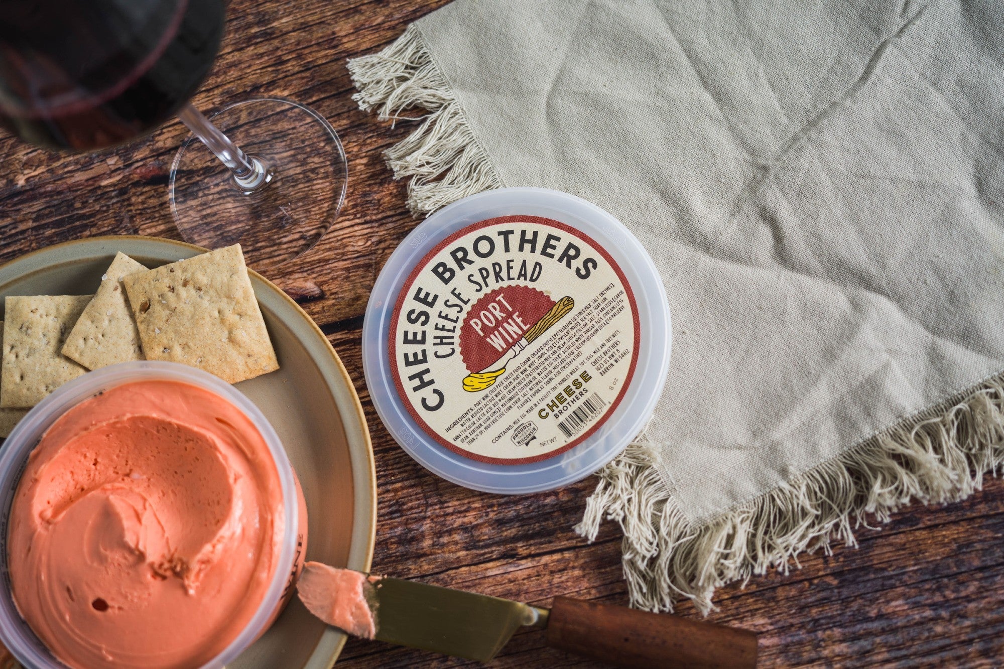 Creamy Port Wine Cheese Spread by Cheese Brothers, Inc., with a smooth texture and rich port wine flavor in a jar.
