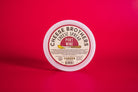 Creamy Port Wine Cheese Spread by Cheese Brothers, Inc. in a jar, showcasing its smooth texture and rich port wine flavor.