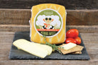 Smoked mozzarella cheese from Cheese Brothers, Inc., showing creamy, sliced smoked mozzarella with a rustic background.