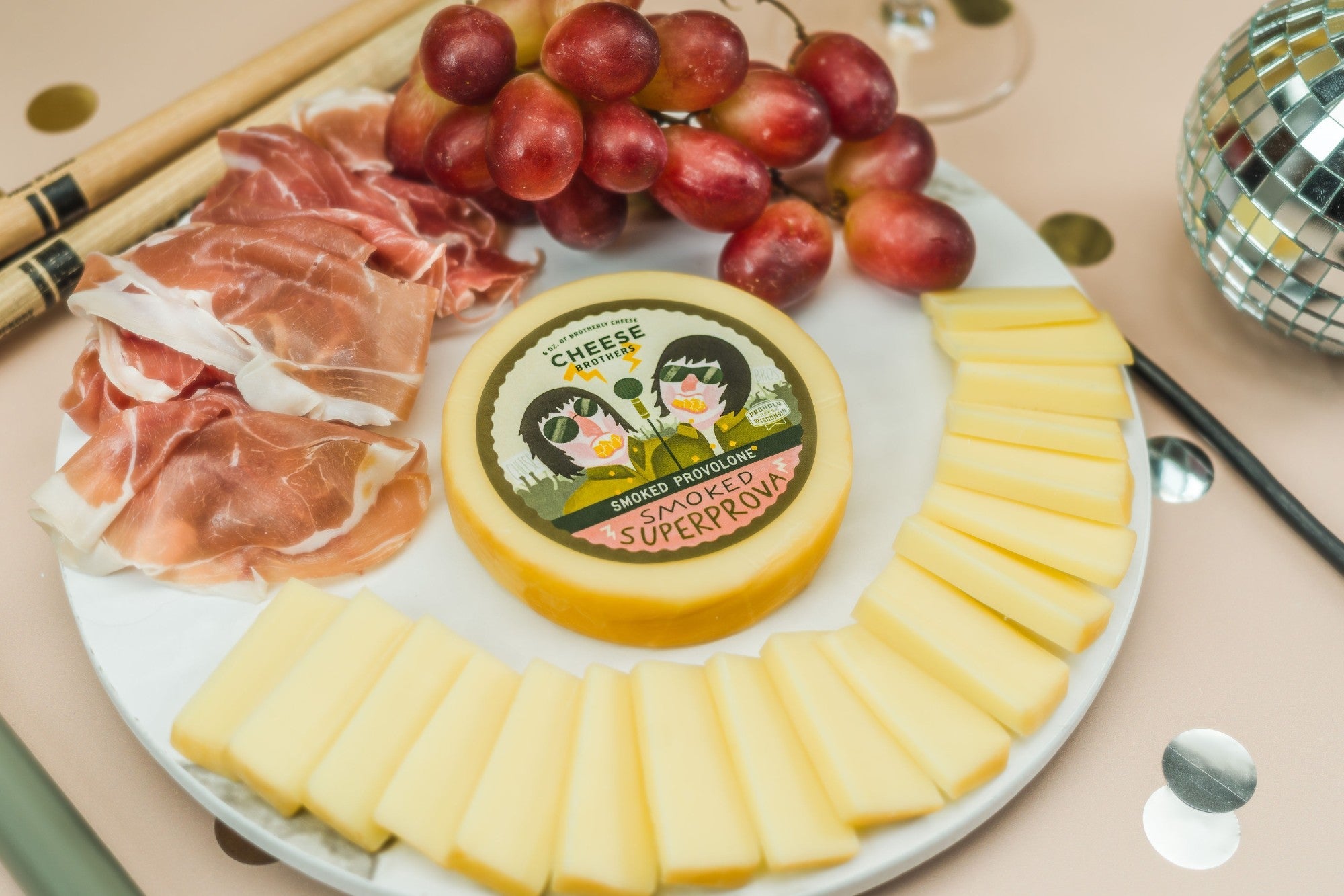 Slices of smoked provolone cheese from Cheese Brothers, Inc., showing the creamy, smoked cheese with a smooth texture.
