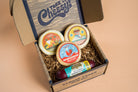 Assorted cheese and sausage sampler pack featuring slices of cheese and cured sausages from Cheese Brothers, Inc.