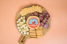 Assorted cheese and sausage sampler pack from Cheese Brothers, Inc., featuring slices of gourmet cheeses and cured sausages.