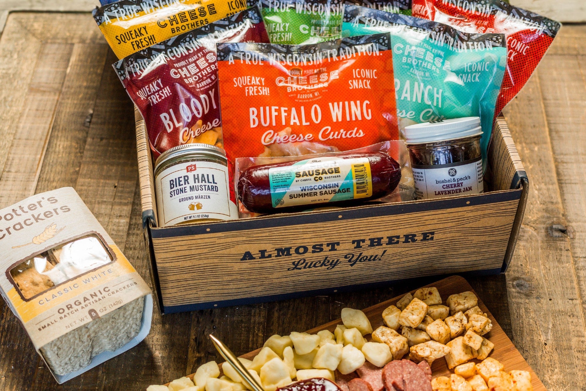 Deluxe Char-CURD-erie box from Cheese Brothers, Inc. featuring assorted cheeses, cured meats, and gourmet accompaniments.