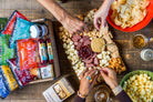 Deluxe Char-CURD-erie gift box from Cheese Brothers, Inc. featuring assorted cheeses, charcuterie, and gourmet treats arranged attractively.