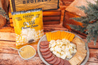 Deluxe Char-CURD-erie gift box from Cheese Brothers, Inc. featuring assorted cheeses and accompaniments in a elegant packaging.