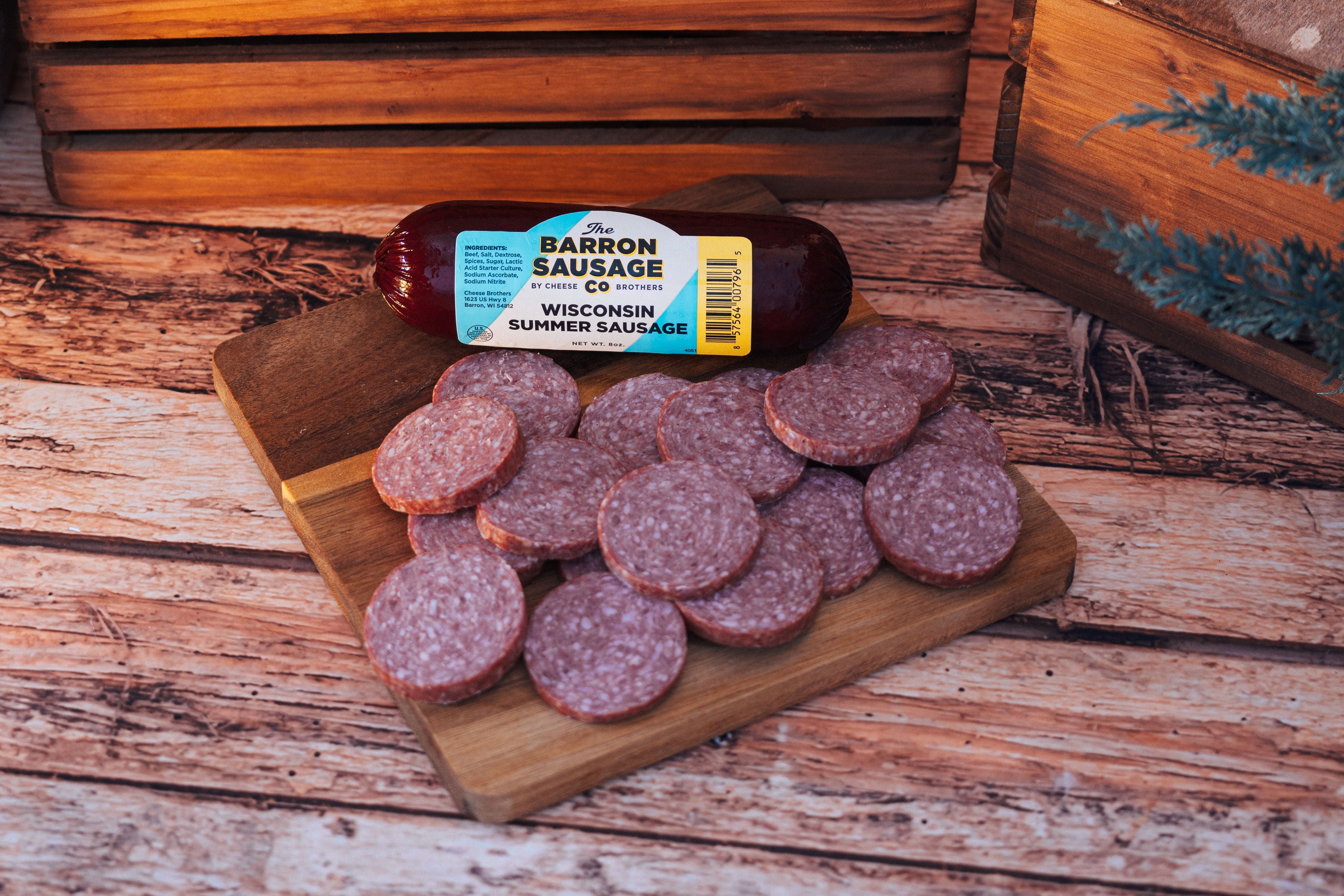 Cheese Brothers Deluxe Char-CURD-erie Box with assorted cheeses and charcuterie items in an elegant gift bundle.
