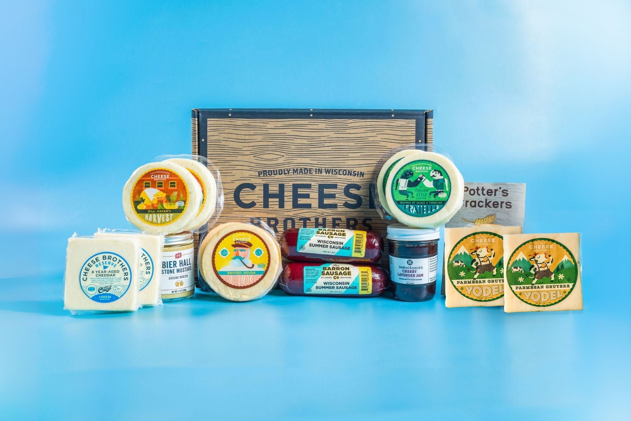 Deluxe Charcuterie Pack from Cheese Brothers, Inc. featuring assorted cured meats, cheeses, and accompaniments on a wooden board.