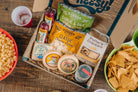 Cheese Brothers Deluxe Game Day Essentials Gift Pack including snacks and drinks in a branded gift box for sports fans.