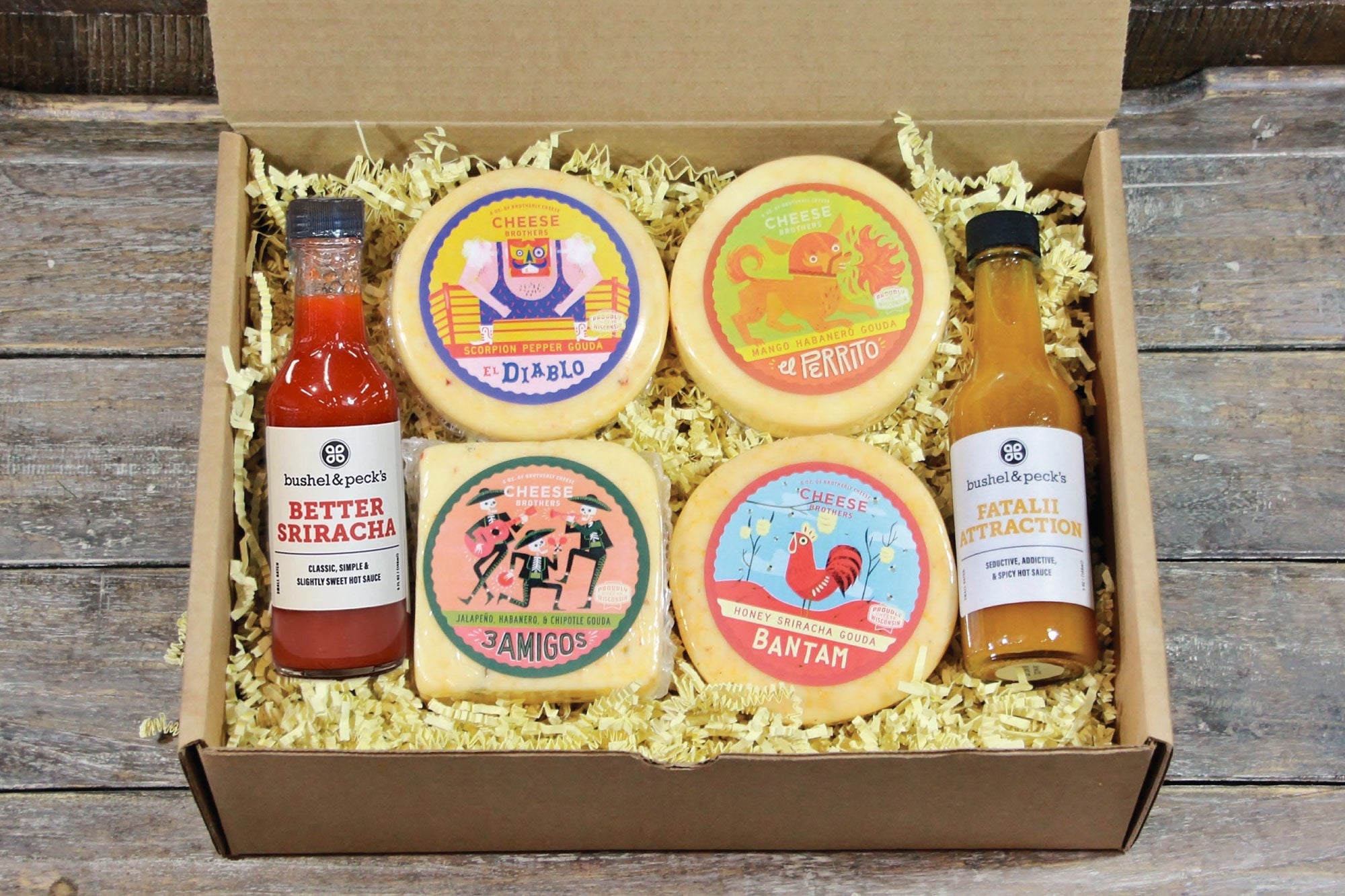 Deluxe hot and spicy gift collection by Cheese Brothers, Inc. featuring assorted spicy cheeses and gourmet snacks.