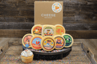 Cheesy Birthday gift basket from Cheese Brothers, Inc. with assorted cheeses, snacks, and birthday-themed items in a colorful box.