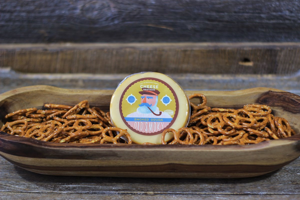 Cheesy birthday gift basket from Cheese Brothers Inc. with assorted cheeses, snacks, and birthday-themed items.