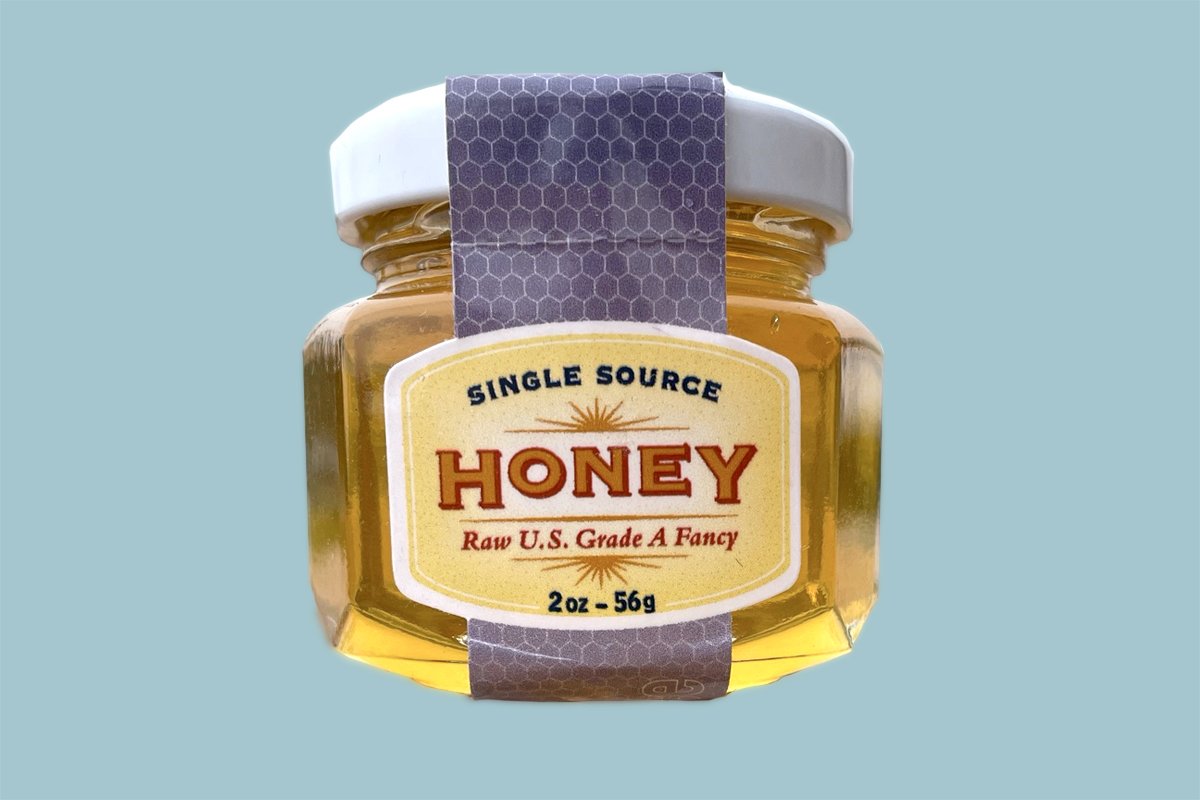 Cheddar cheese gift basket from Cheese Brothers Inc. with honey jars, assorted cheeses, and gourmet snack items for gift-giving.