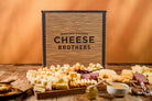 Cheese Brothers, Inc. Just About Everything Box featuring a variety of gourmet cheeses, snacks, and gift items in a colorful gift bundle.