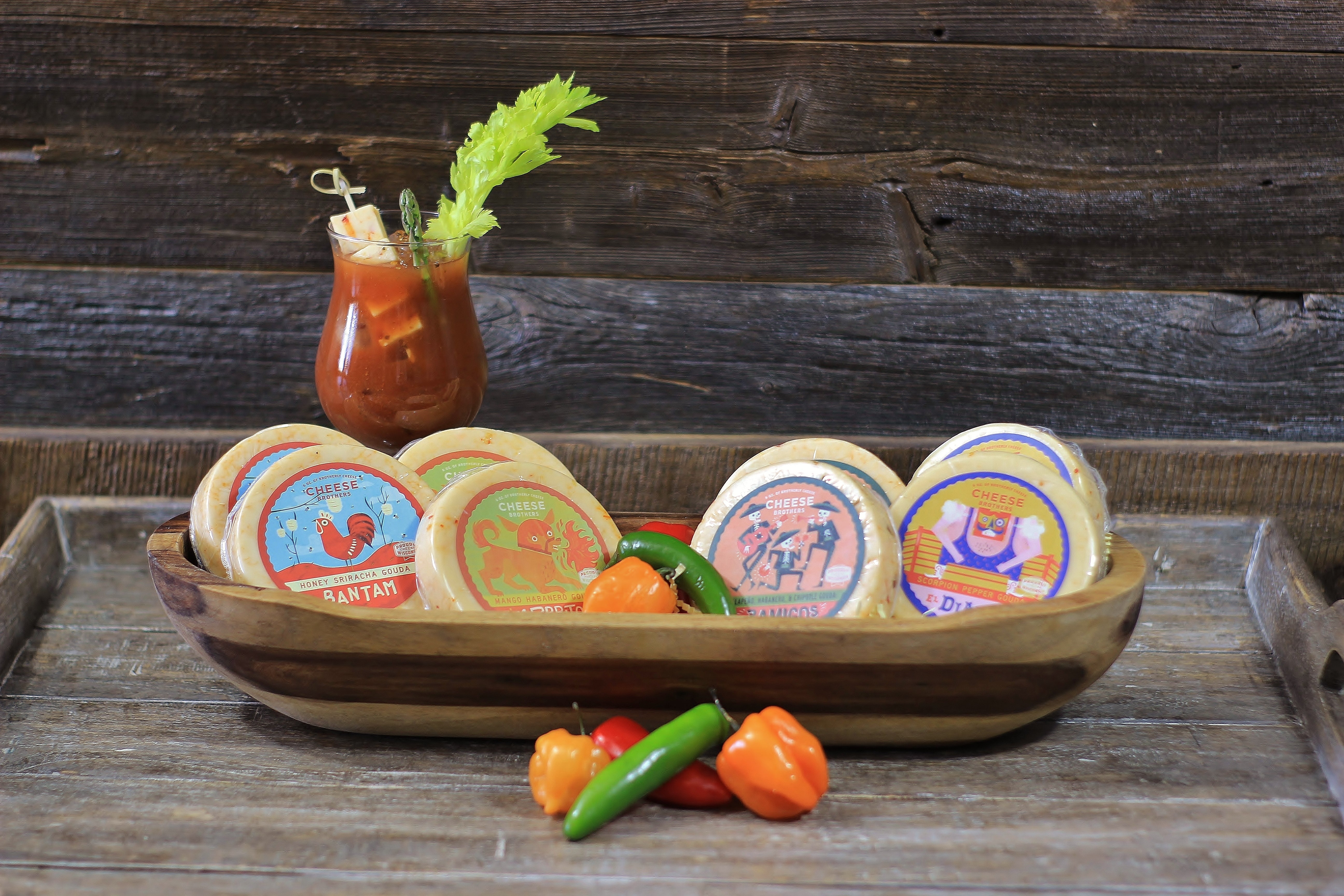 Assorted spicy cheese lovers pack with 8 varieties from Cheese Brothers, Inc., showcasing a variety of colorful cheese wedges.