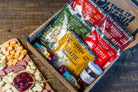 Char-CURD-erie cheese and charcuterie gift box from Cheese Brothers, Inc., featuring an assortment of cheeses and cured meats.