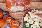 Tomato basil gift bundle from Cheese Brothers, Inc., featuring fresh tomatoes, basil, and artisanal cheese products in a curated box.