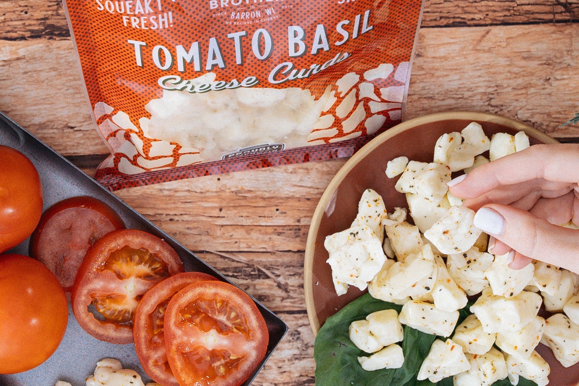 Tomato basil gift bundle from Cheese Brothers, Inc., featuring fresh tomatoes, basil, and artisanal cheese products in a curated box.