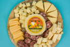 Assorted charcuterie pack from Cheese Brothers, Inc. featuring cured meats, cheeses, crackers, and accompaniments for a gourmet snack platter.