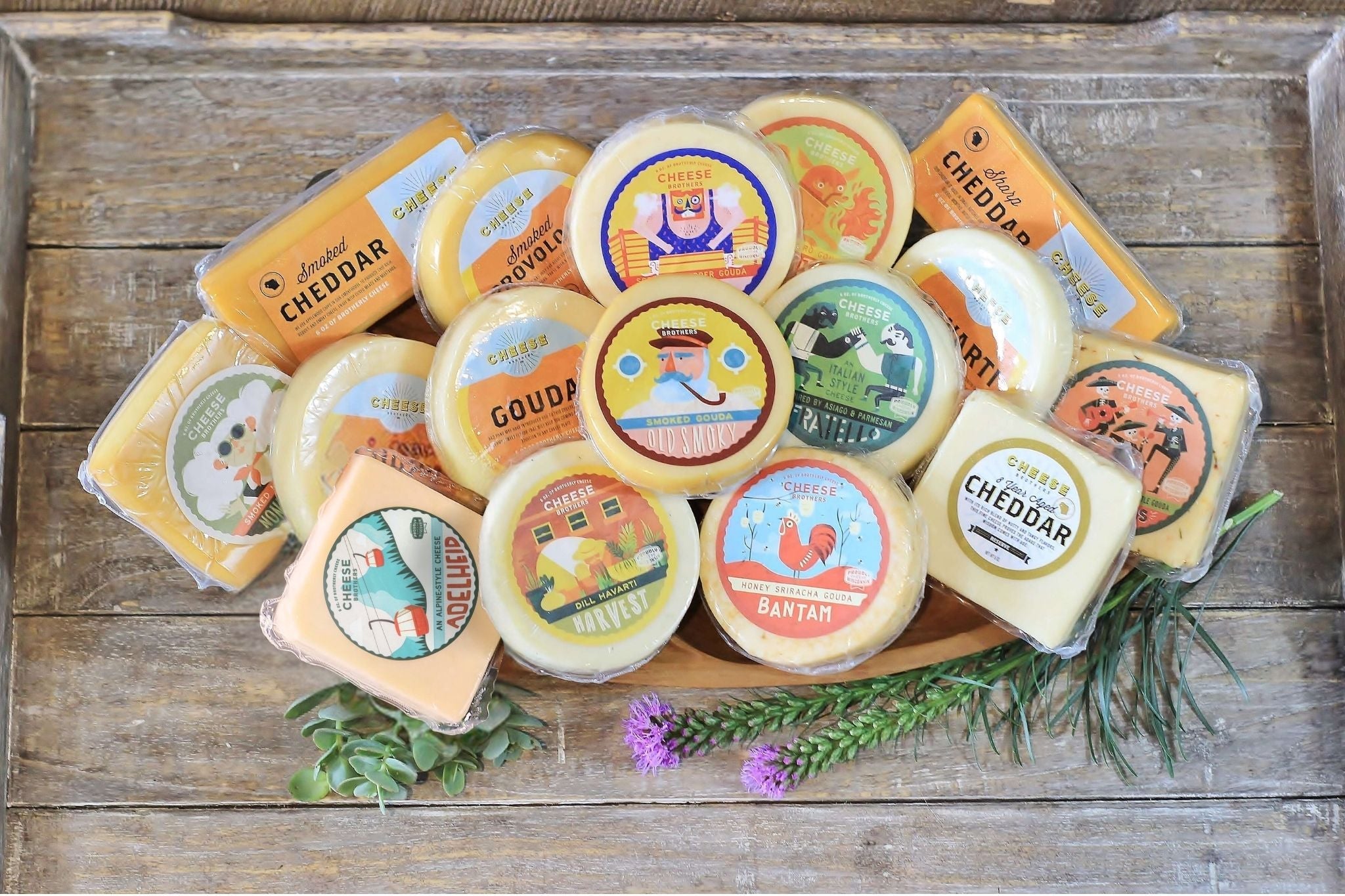 Assorted Wisconsin cheese sampler gift box from Cheese Brothers, Inc., featuring a variety of cheeses in an attractive packaging.