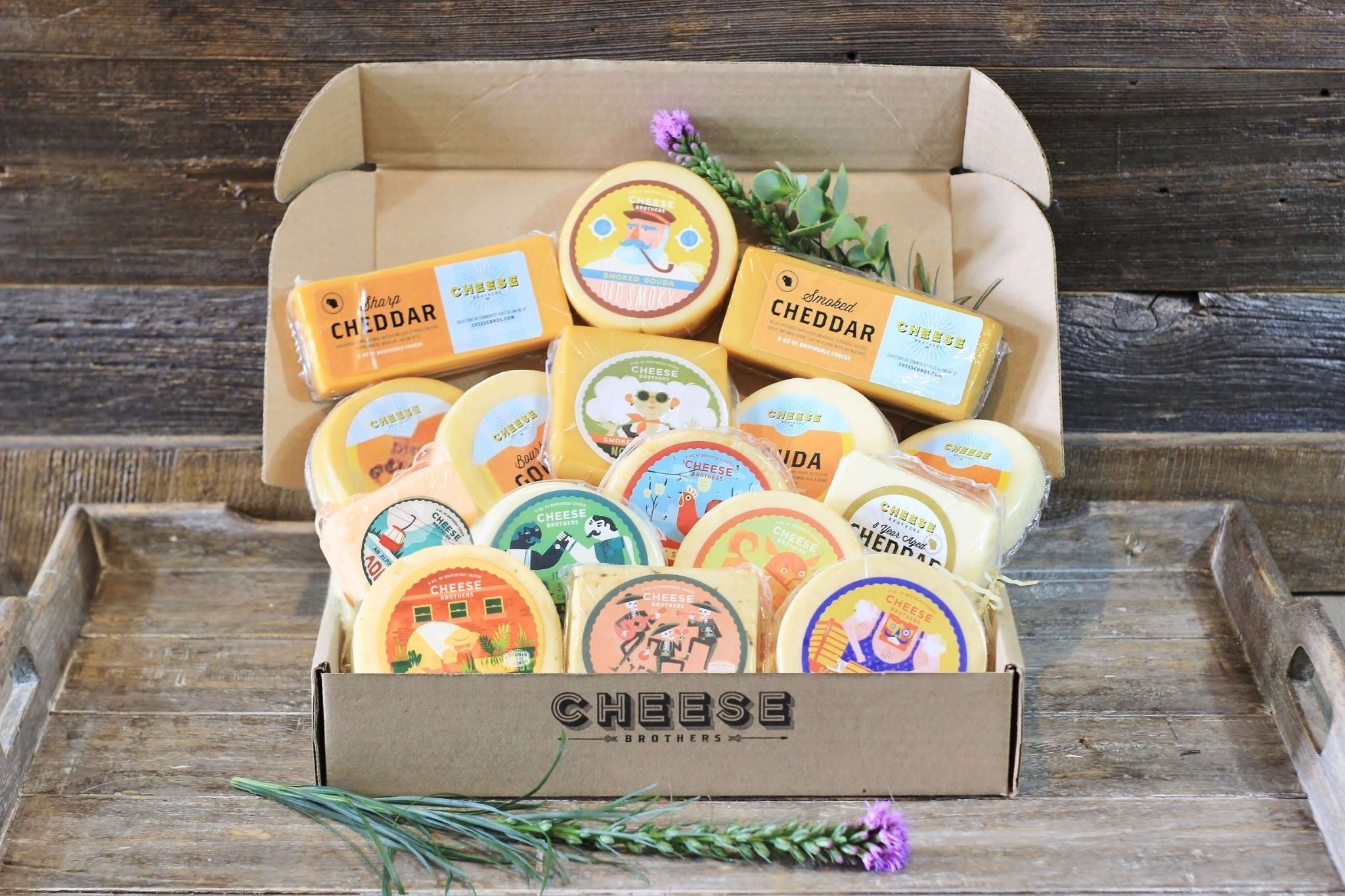 Assorted Wisconsin cheese sampler gift box from Cheese Brothers, Inc., featuring a variety of cheeses in a decorative package.