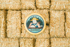 Creamy Bluegrass Bourbon Gouda cheese from Cheese Brothers, Inc., showing a wedge of rich, smooth Gouda with a blue hue and bourbon infusion.