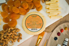 Creamy Classic Gouda cheese from Cheese Brothers, Inc., featuring a smooth, golden wedge sliced to show its rich texture.