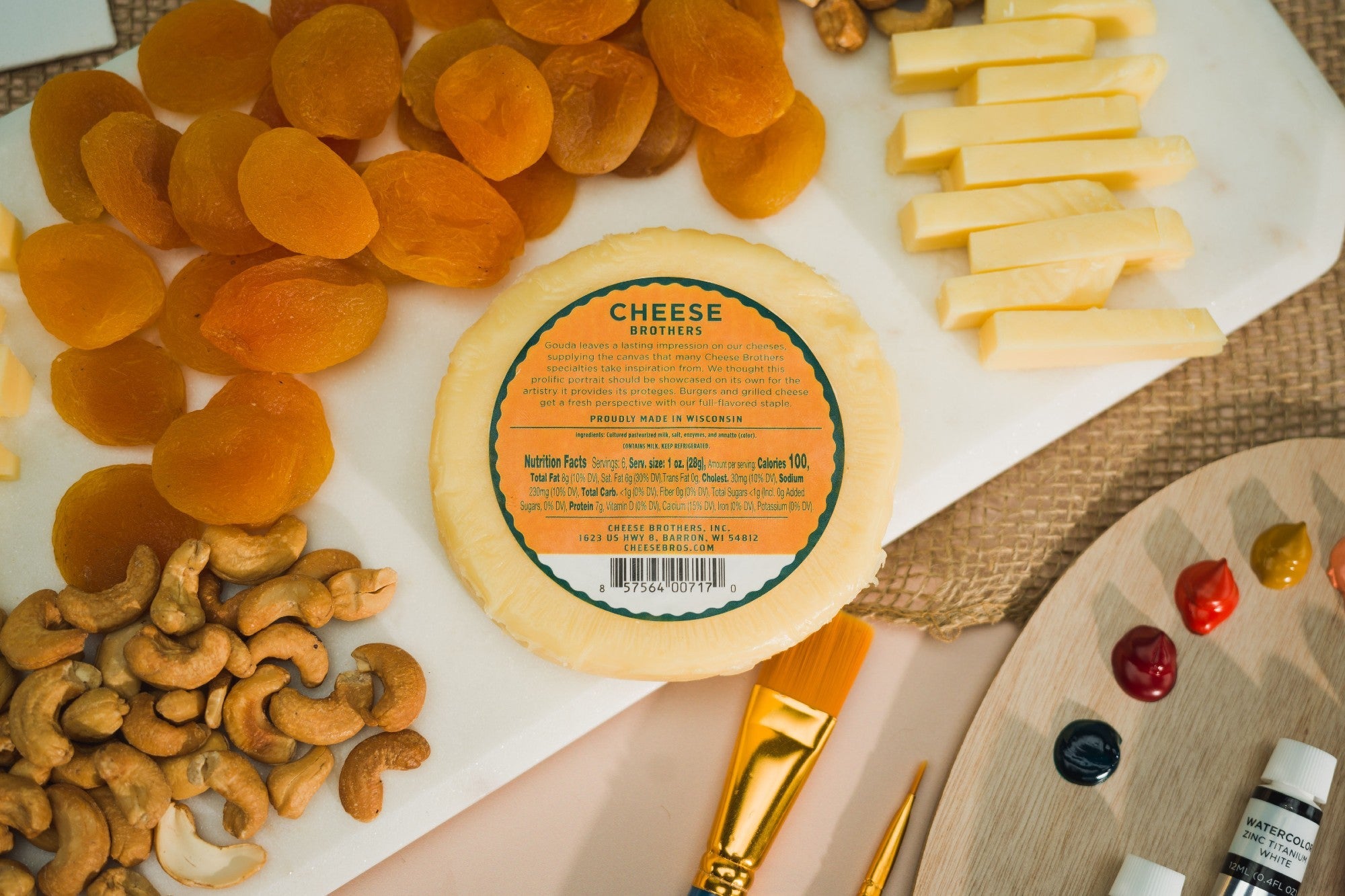 Creamy Classic Gouda cheese from Cheese Brothers, Inc., featuring a smooth, golden wedge sliced to show its rich texture.