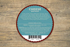 A wedge of smoked Gouda cheese from Cheese Brothers, Inc., showing its rich, smoky flavor and smooth, golden texture.