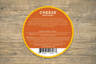 Sliced Dill Havarti cheese from Cheese Brothers, Inc., showing creamy cheese with visible dill herb inclusions.