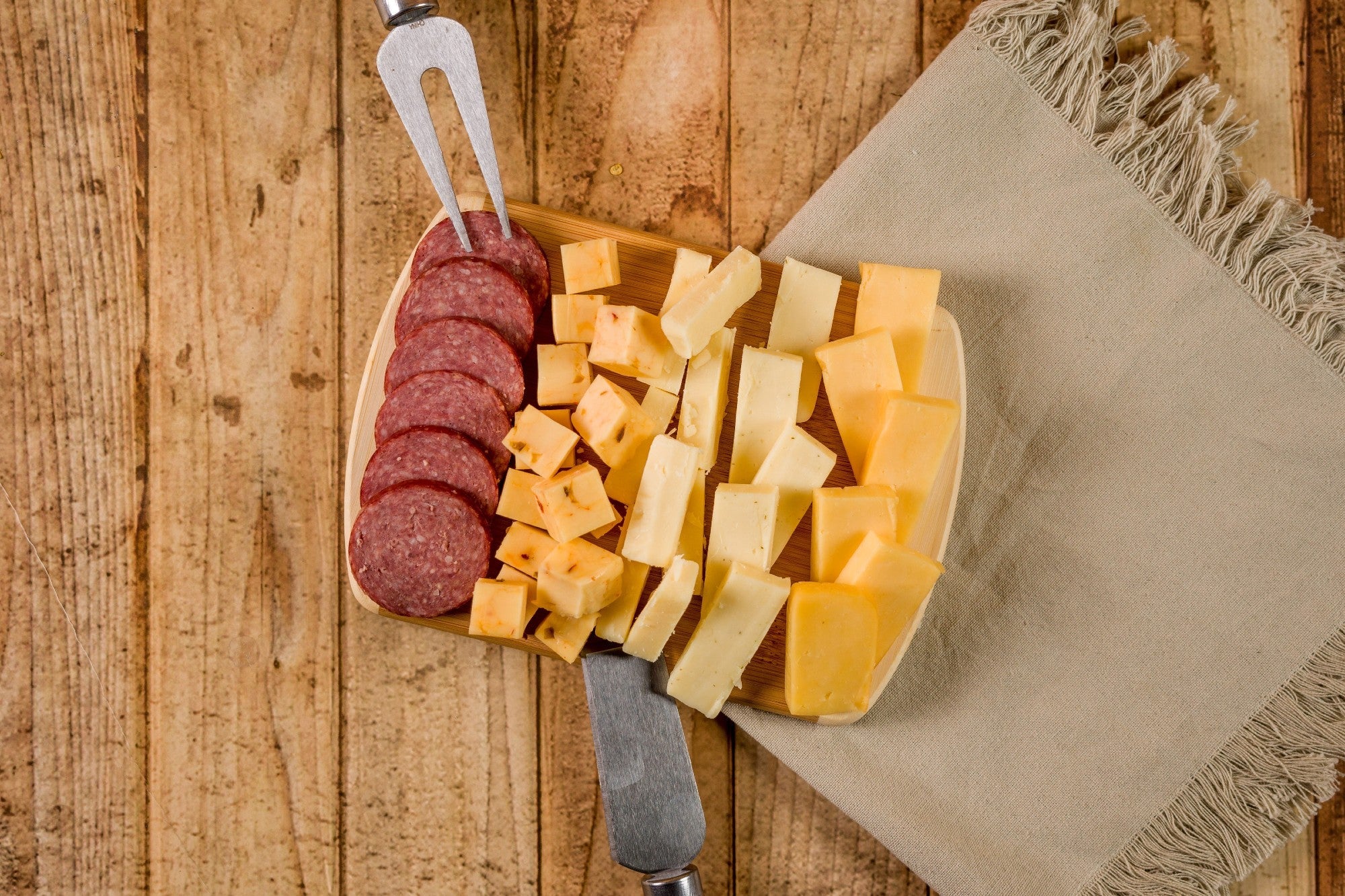 Cheese Brothers Inc. 8-inch wooden cutting board for cheese and kitchen prep, featuring natural wood grain and smooth edges.