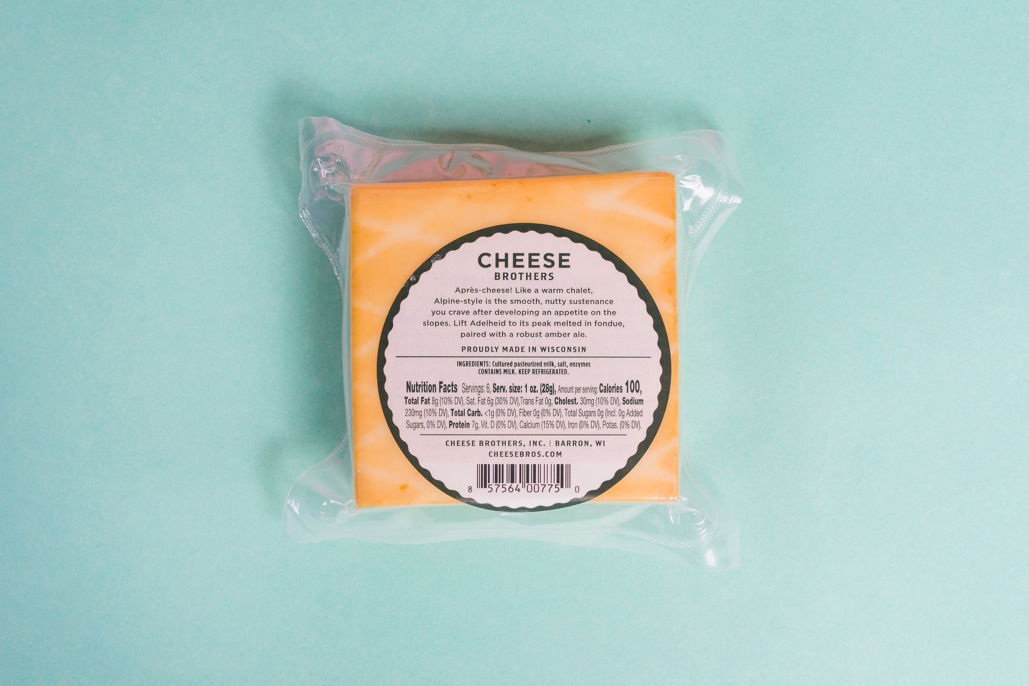 Adelheid Alpine-Style Cheese from Cheese Brothers, Inc., creamy cheese wheel with a rustic rind, ideal for cheese platters.