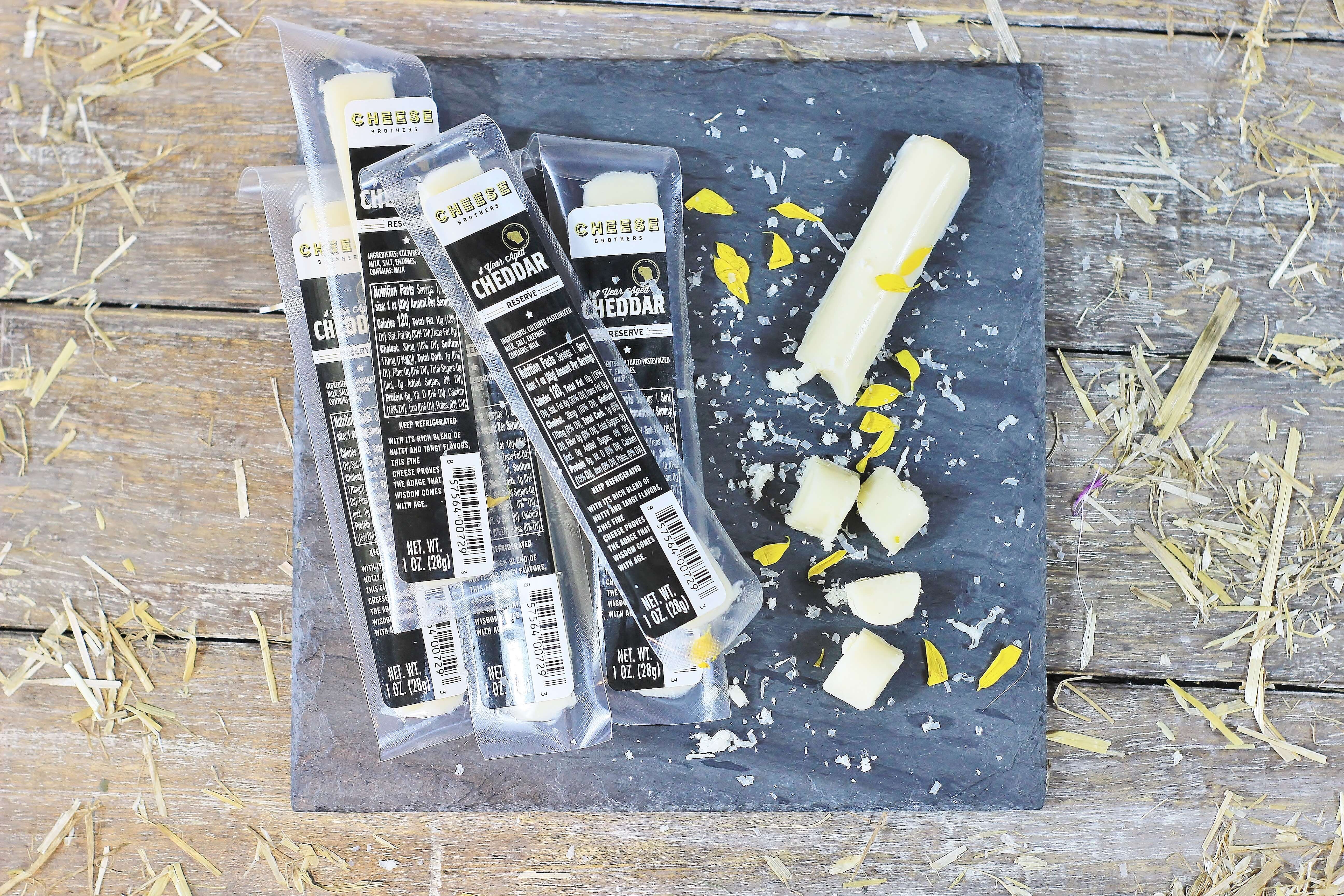 Closeup of Cheese Brothers 8-Year Aged Cheddar Snack Sticks in a 30-pack, showing golden, crispy snack sticks ready to eat.