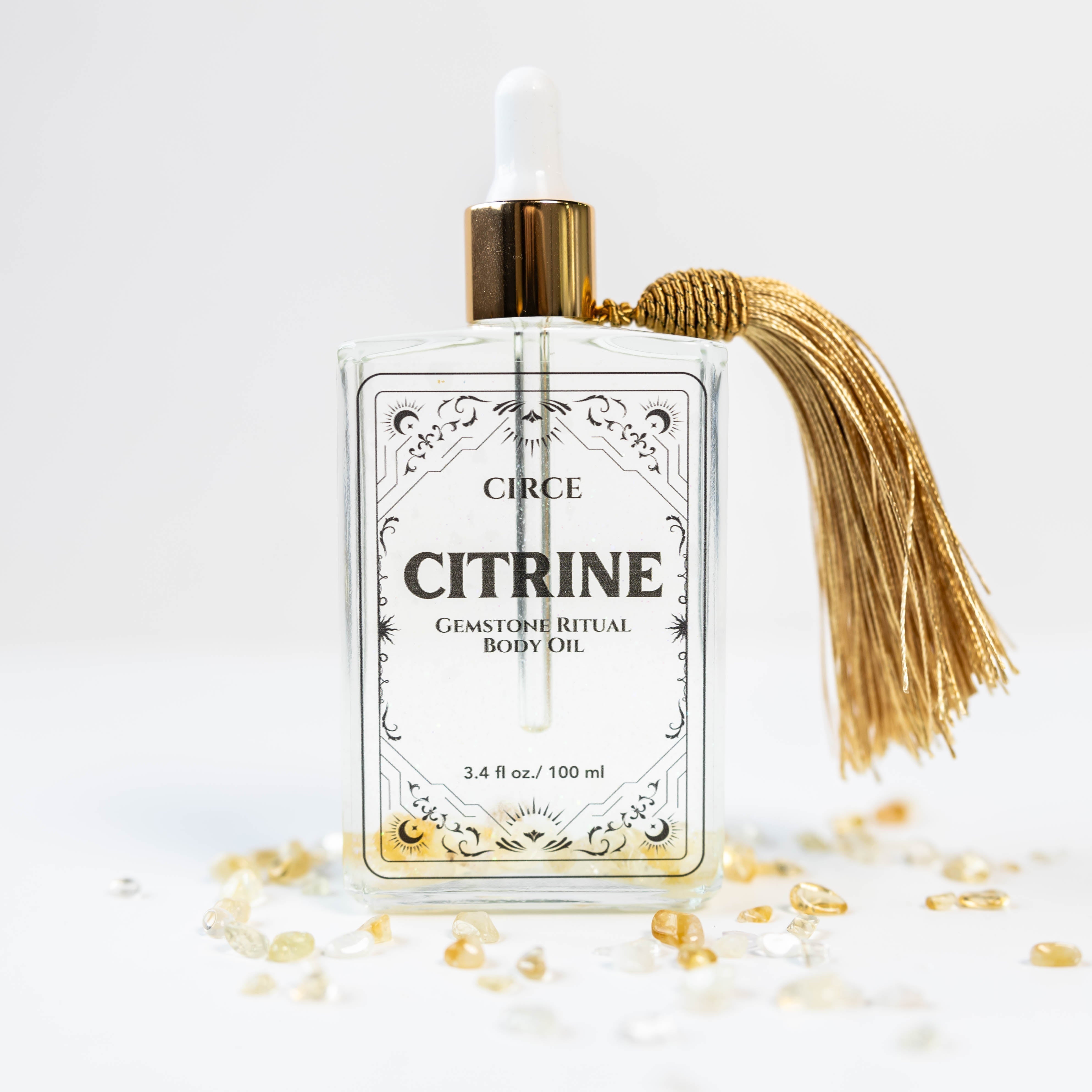 Citrine gemstone body oil by Circe Boutique with a glass bottle and gold accents, showcasing the abundance and crystal glow ritual oil.
