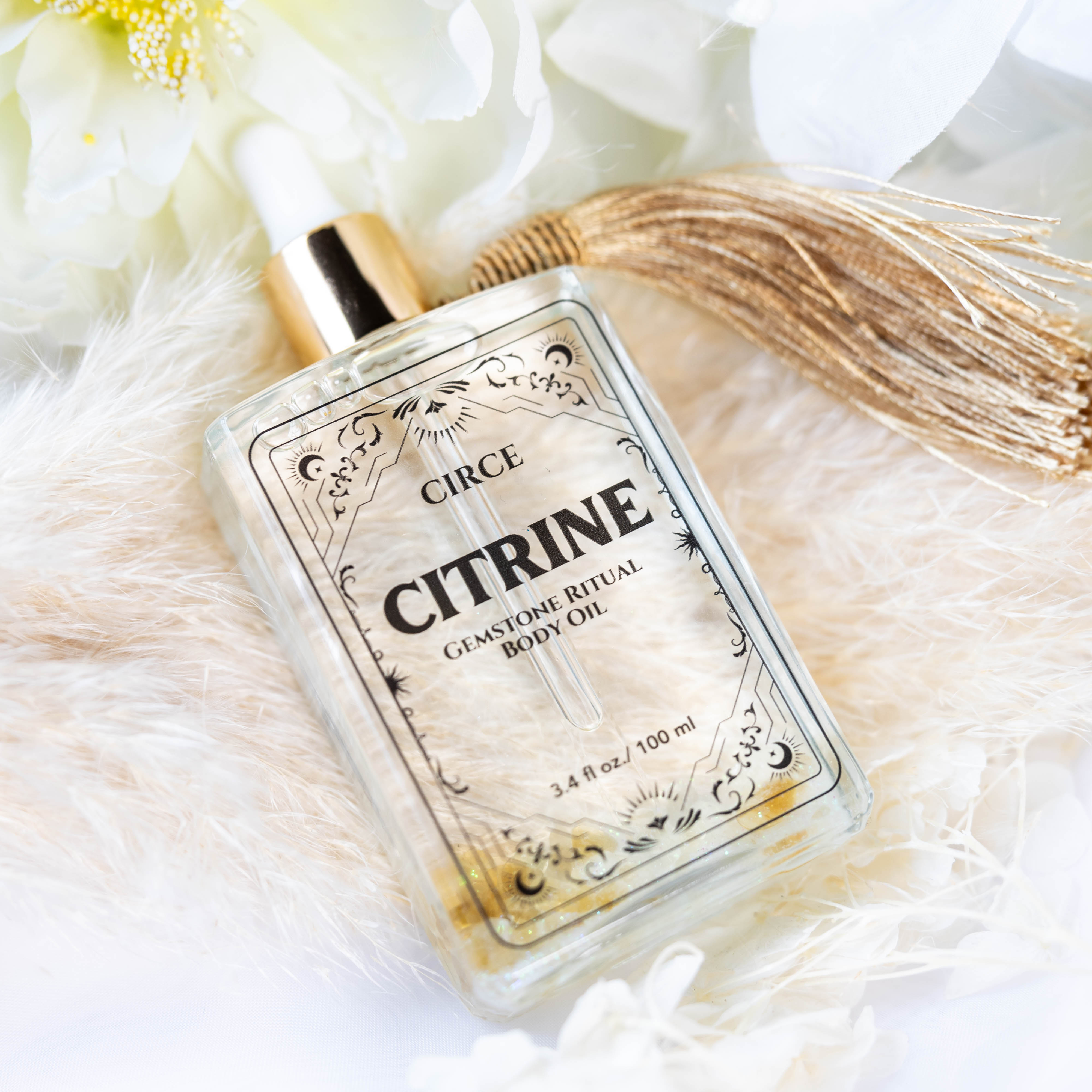 Citrine gemstone body oil by Circe Boutique, featuring a clear bottle with golden oil and a citrine gemstone for abundance and glow.