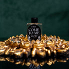 Come To Me Attraction Oil by Circe Boutique, a magnetic love ritual oil bottle with a dark glass container and silver cap.