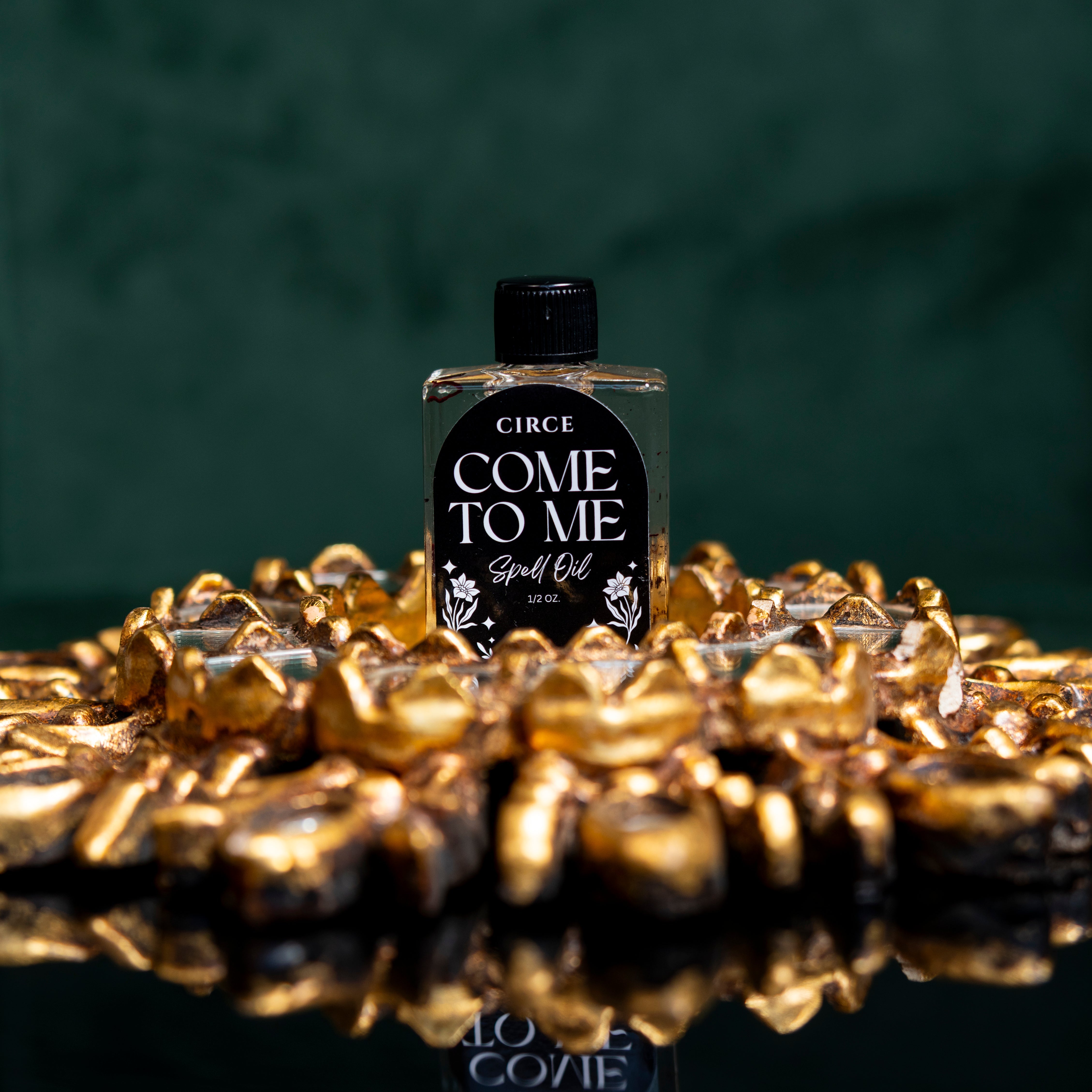 Come To Me Attraction Oil by Circe Boutique, a magnetic love ritual oil bottle with a dark glass container and silver cap.