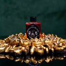 Bottle of Circe Boutique Dragon's Blood Ritual Oil for protection and power, with dark red liquid and ornate label.