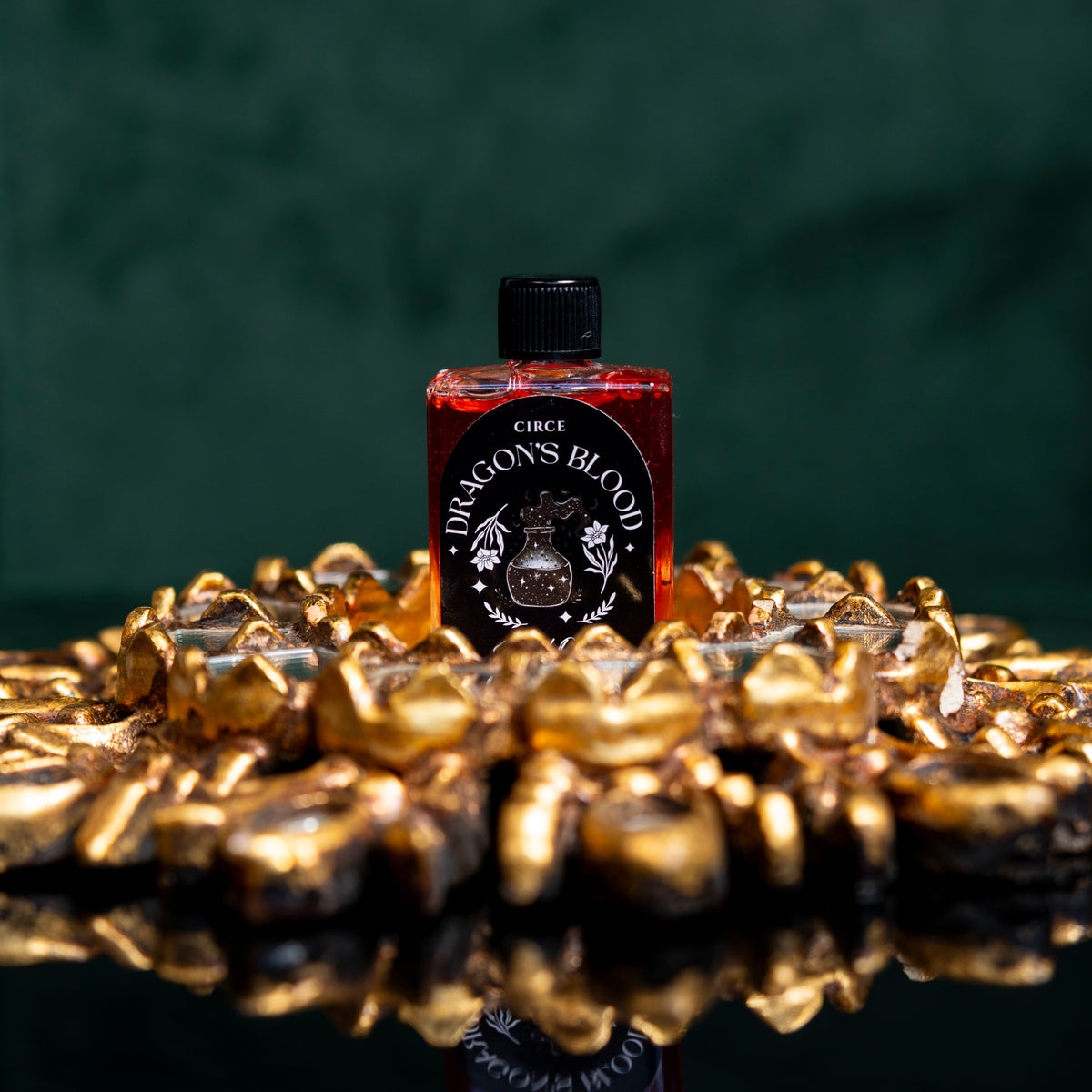 Bottle of Circe Boutique Dragon's Blood Ritual Oil for protection and power, with dark red liquid and ornate label.