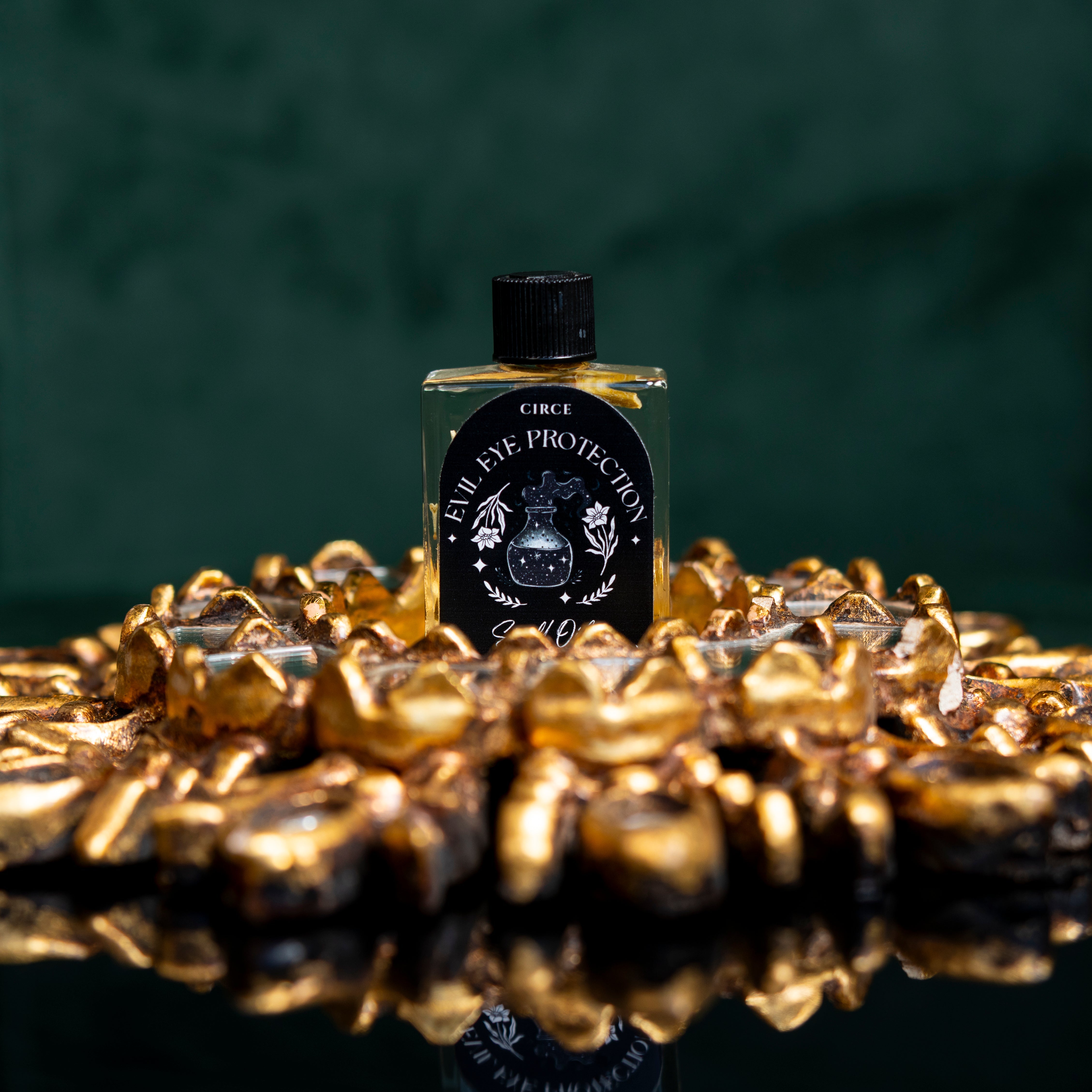 Evil Eye Protection Oil from Circe Boutique, ritual shielding anointing oil in a small glass bottle with dropper.