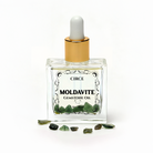 Two 1 oz bottles of Circe Boutique Moldavite Ritual Oil with gemstone accents, used for manifestation and spiritual transformation.