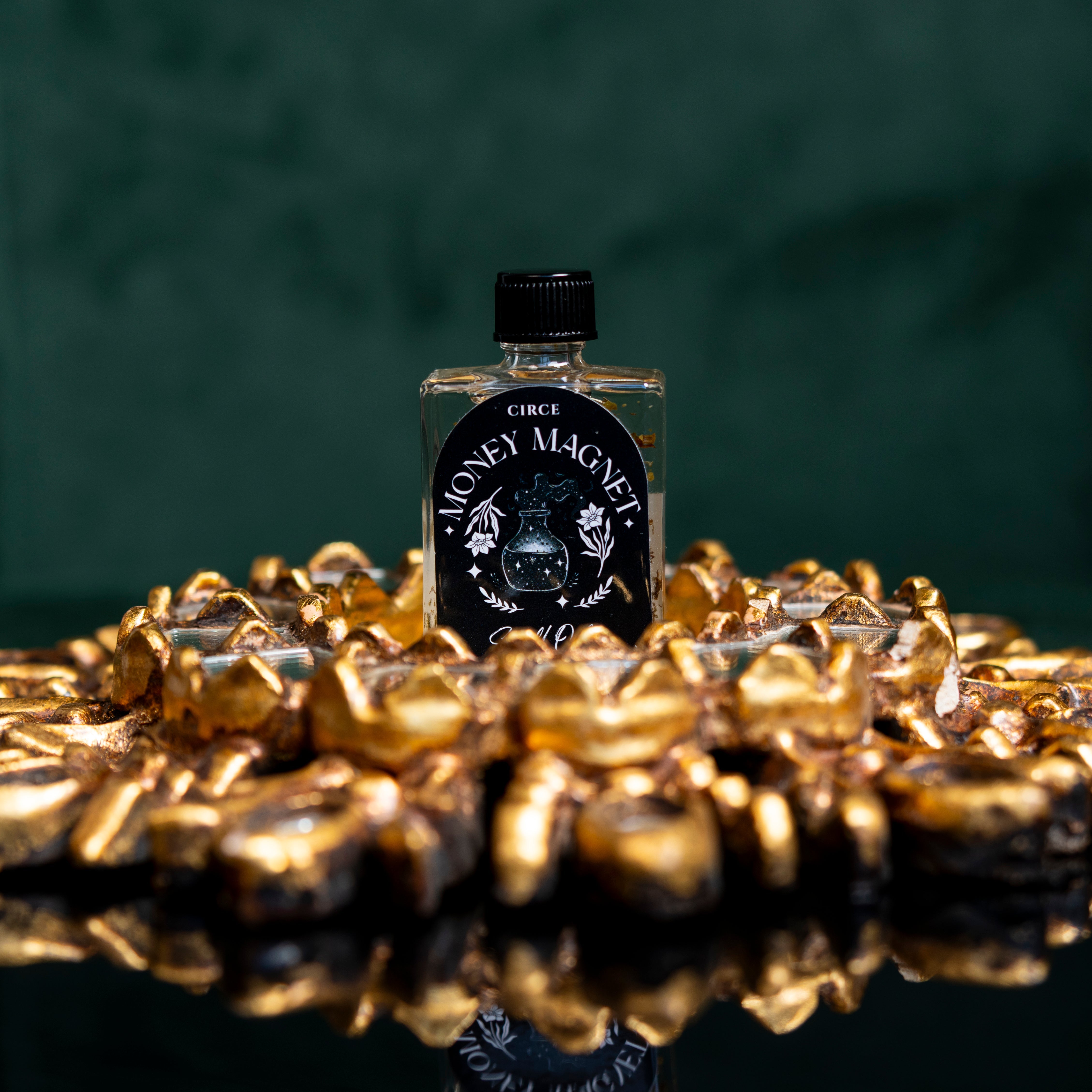 Small bottle of Money Magnet spell oil from Circe Boutique, featuring a 1/2 oz glass container with a black cap and decorative label.
