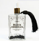 Protection Body Oil with obsidian crystal, Circe Boutique ritual oil in a sleek bottle, designed for spiritual protection and skin nourishment.