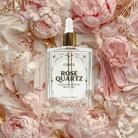 Rose Quartz body oil by Circe Boutique, 3.4 oz, featuring a clear bottle with pink-tinted oil and a rose quartz crystal inside.