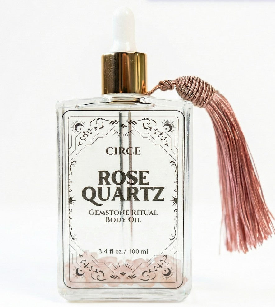 Rose quartz body oil from Circe Boutique, featuring a 3.4 oz bottle with rose quartz crystals for self-love and glowing skin.